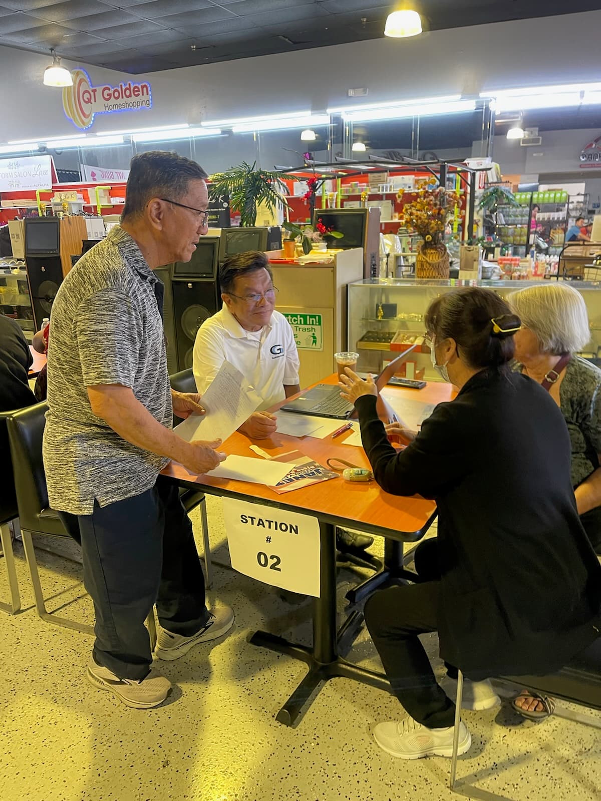 Phat Bui helping a resident with housing assistance